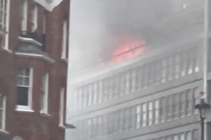 Huge fire rips through London tower block with flats engulfed in flames as 75 firefighters scrambled Residents flee as huge fire engulfs Westminster block of flats